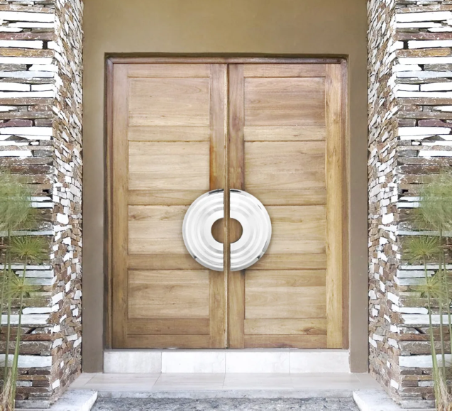 Oversized circular door pulls on a pair of wood entry doors