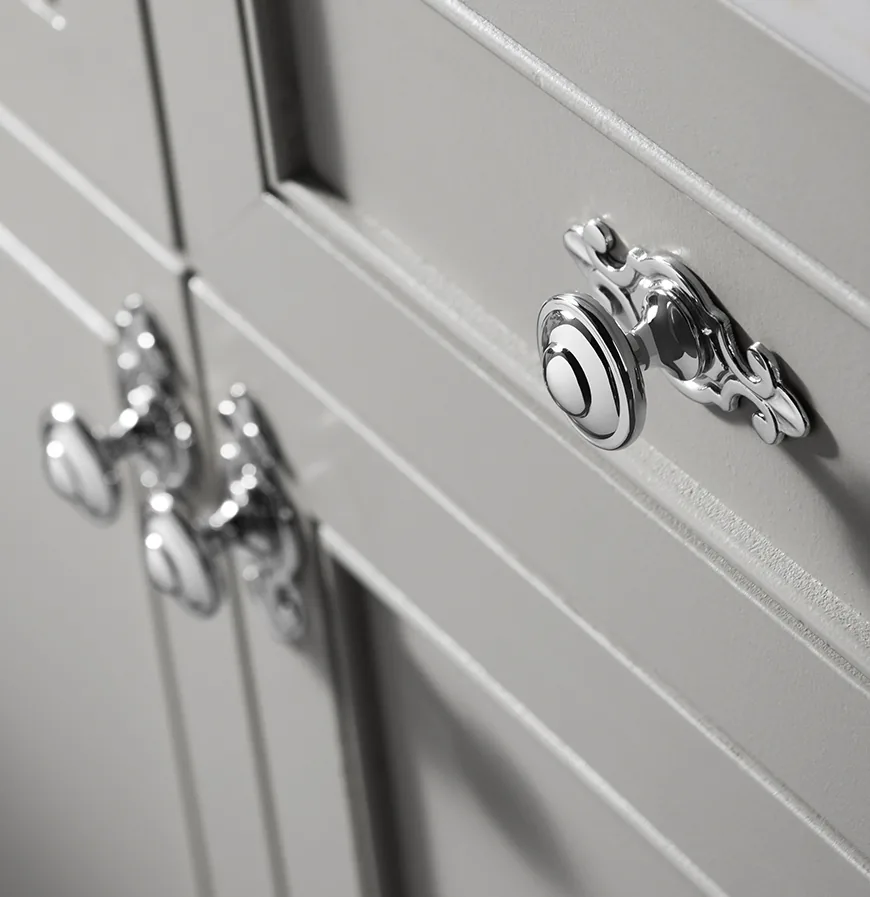 Ornate polished chrome cabinet hardware with decorative back plates
