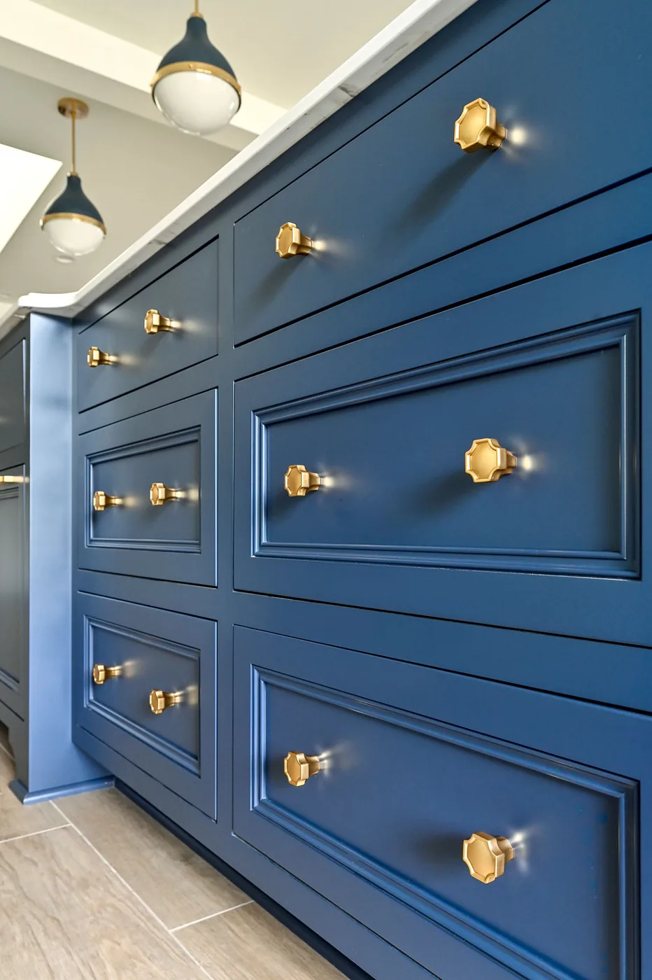 Blue cabinetry with brass and glass cabinet knobs